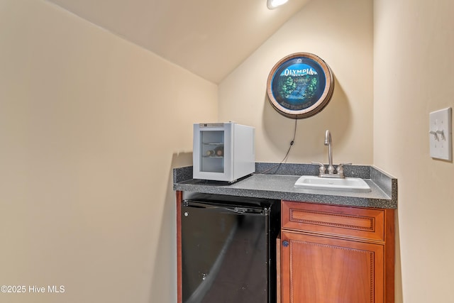 laundry area with indoor wet bar and a sink