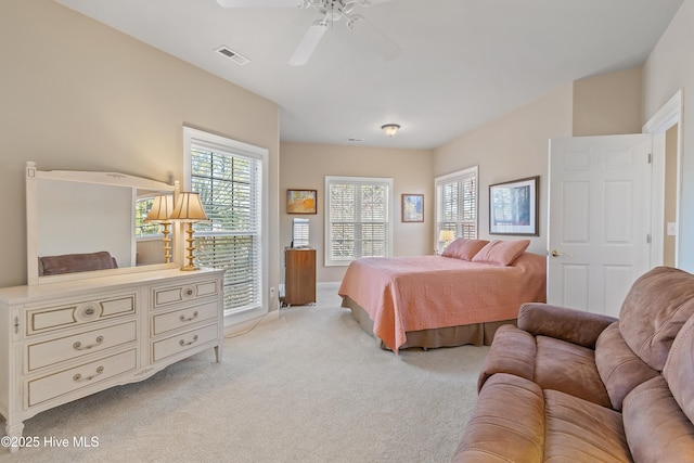 bedroom with baseboards, a ceiling fan, visible vents, and carpet