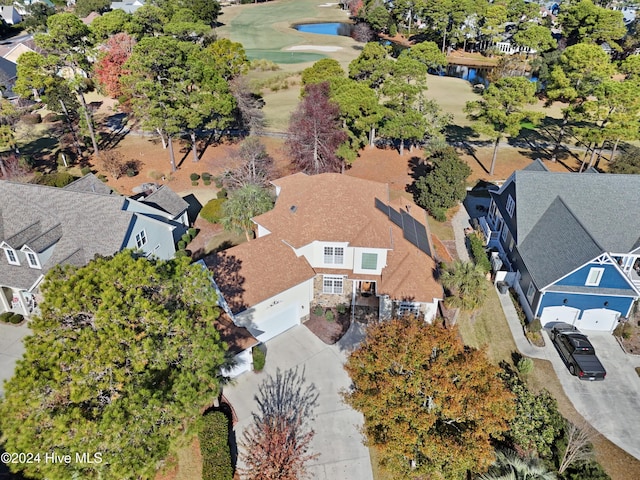 drone / aerial view featuring a residential view, a water view, and view of golf course