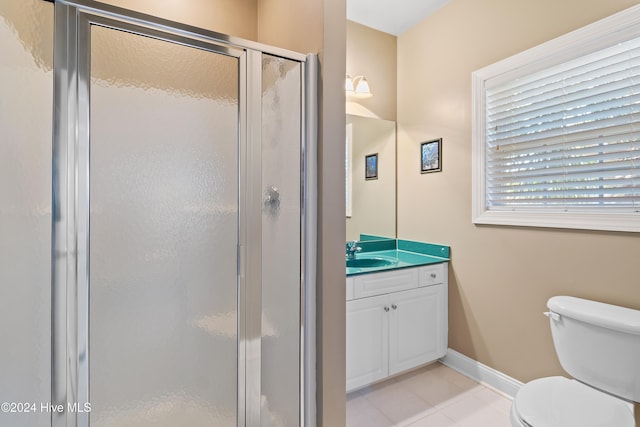 full bath featuring tile patterned flooring, toilet, vanity, baseboards, and a shower stall