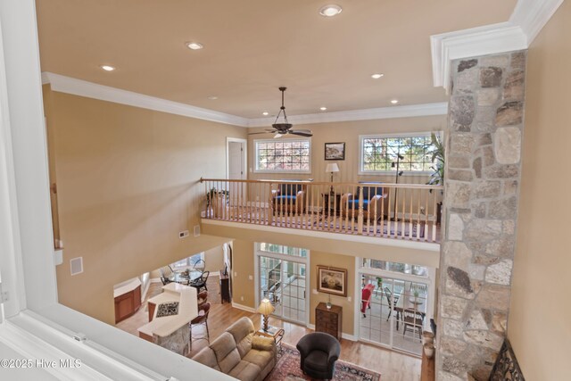living room with recessed lighting, wood finished floors, ornamental molding, and ceiling fan
