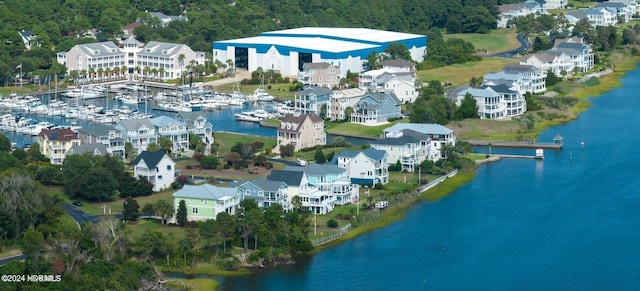 bird's eye view with a water view and a wooded view