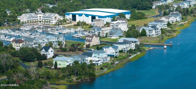 view of property's community with a water view and a yard