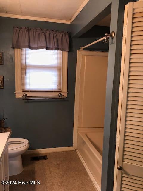 bathroom with vanity, toilet, and crown molding