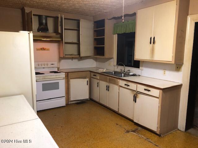 kitchen featuring a textured ceiling, sink, exhaust hood, and white appliances