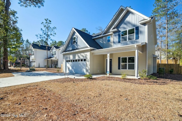 view of front of home featuring covered porch and a garage