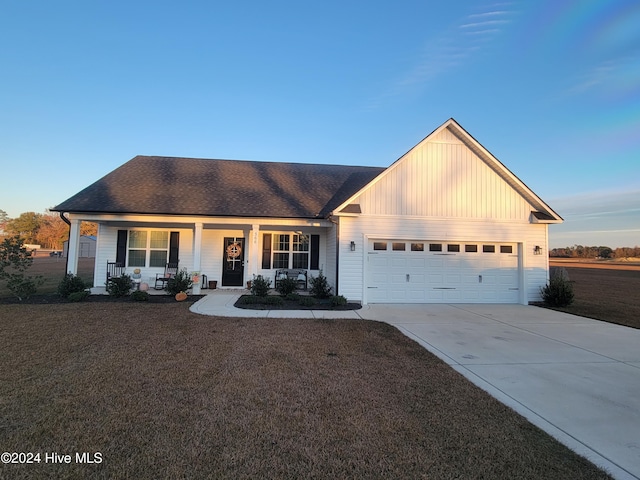 single story home with a porch and a garage