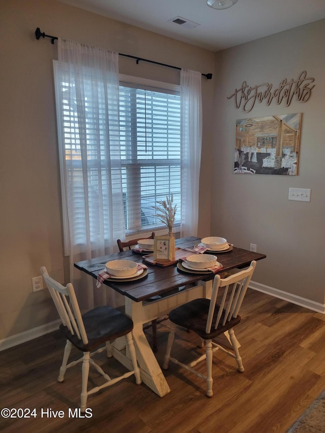 dining room with dark hardwood / wood-style flooring