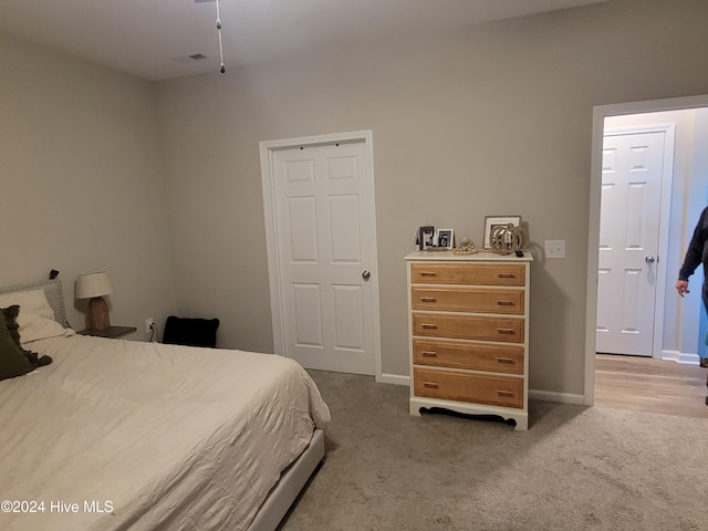 bedroom featuring light carpet