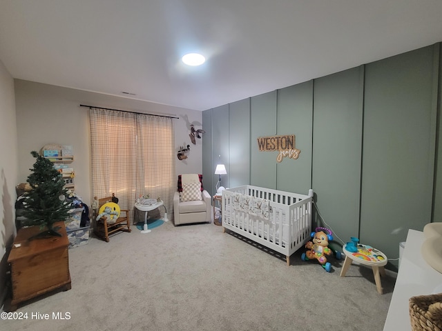 carpeted bedroom with a crib