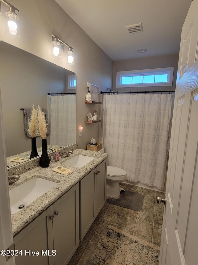 bathroom featuring a shower with curtain, vanity, and toilet