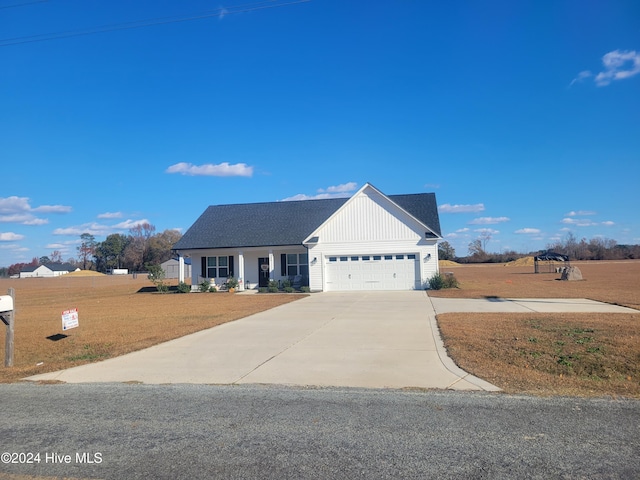 view of front of house with a front yard and a garage