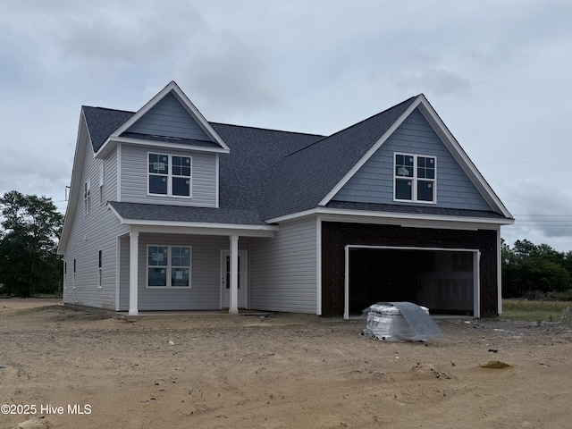 116 Talbert Dr, Rocky Point, NC 28457 - view of front of house featuring a garage, a shingled roof, and a porch