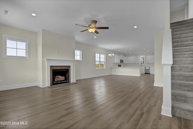 116 Talbert Dr, Rocky Point, NC 28457 - unfurnished living room with stairway, ceiling fan, a fireplace with raised hearth, wood finished floors, and recessed lighting