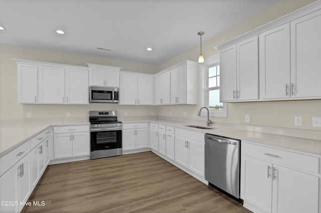 116 Talbert Dr, Rocky Point, NC 28457 - kitchen with appliances with stainless steel finishes, white cabinetry, recessed lighting, light countertops, and pendant lighting