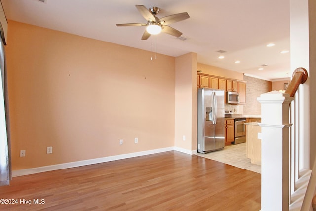 kitchen featuring decorative backsplash, ceiling fan, light hardwood / wood-style flooring, and appliances with stainless steel finishes