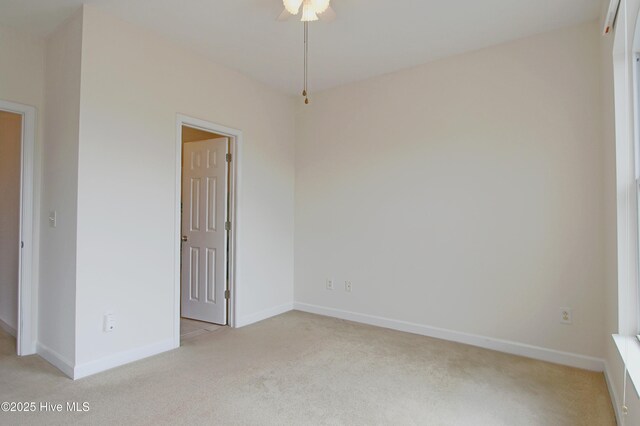 unfurnished bedroom featuring light carpet and ensuite bathroom