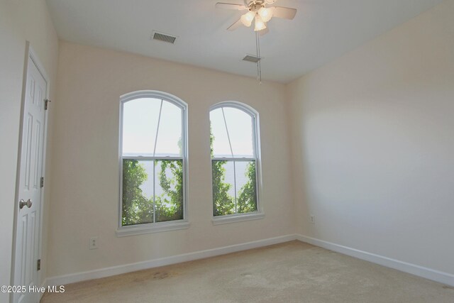 empty room with light carpet and ceiling fan