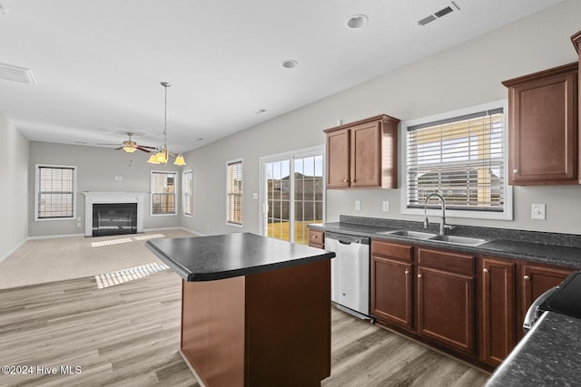 kitchen with dishwasher, sink, hardwood / wood-style flooring, ceiling fan, and a kitchen island