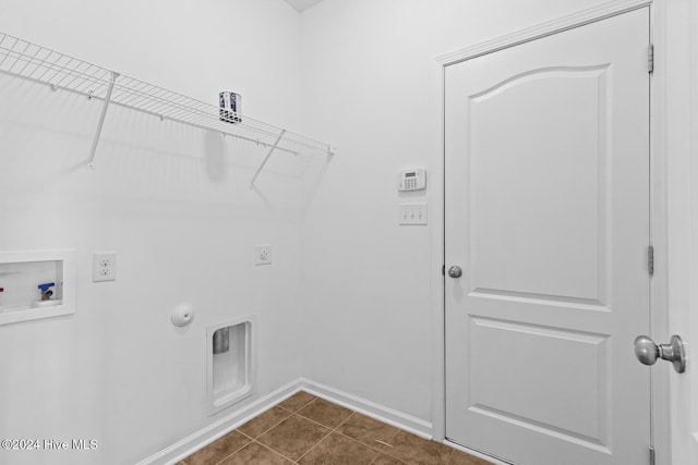 clothes washing area featuring hookup for a gas dryer, hookup for a washing machine, dark tile patterned floors, and hookup for an electric dryer