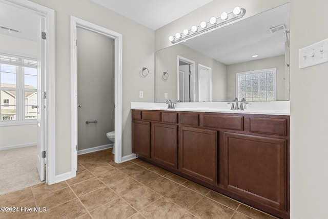 bathroom featuring tile patterned floors, vanity, and toilet