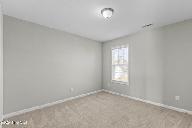 unfurnished room featuring light colored carpet