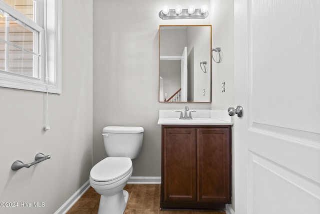 bathroom featuring tile patterned floors, vanity, and toilet