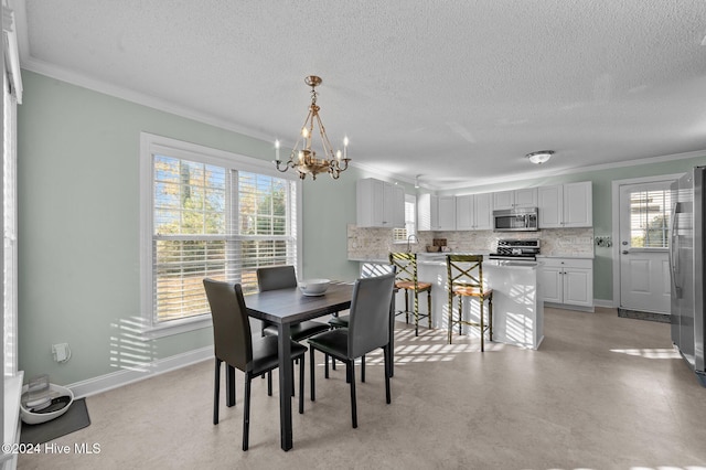 dining space with ornamental molding, a notable chandelier, and a textured ceiling