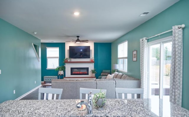 dining area with hardwood / wood-style flooring and ceiling fan