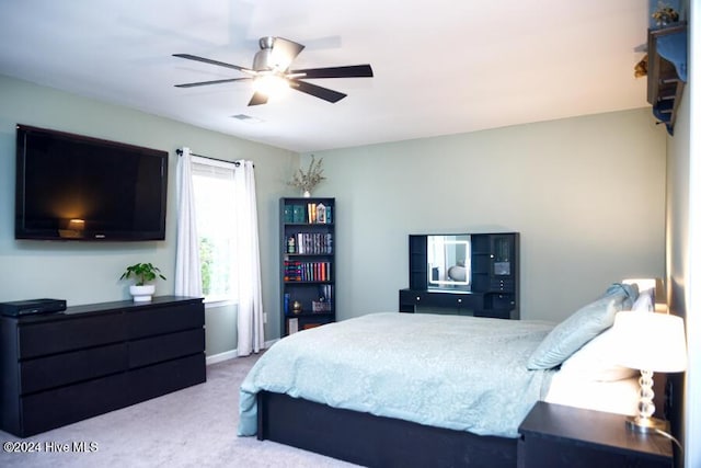 bedroom with light carpet and ceiling fan