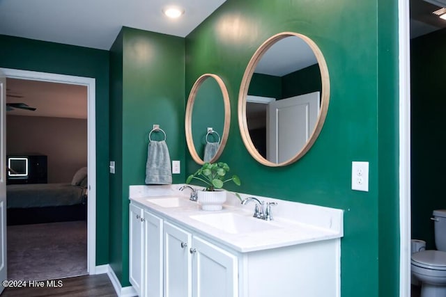 bathroom featuring vanity, hardwood / wood-style floors, and toilet