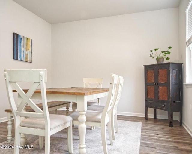 dining area with dark hardwood / wood-style floors