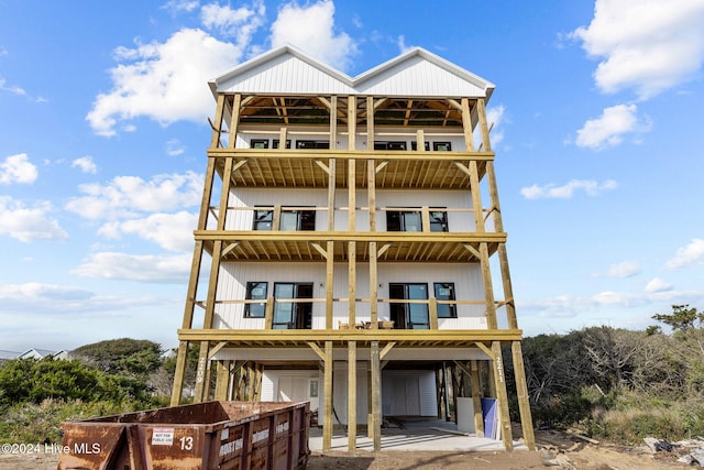 view of front of property with a balcony and a carport