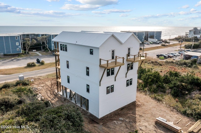 exterior space with a water view and a balcony