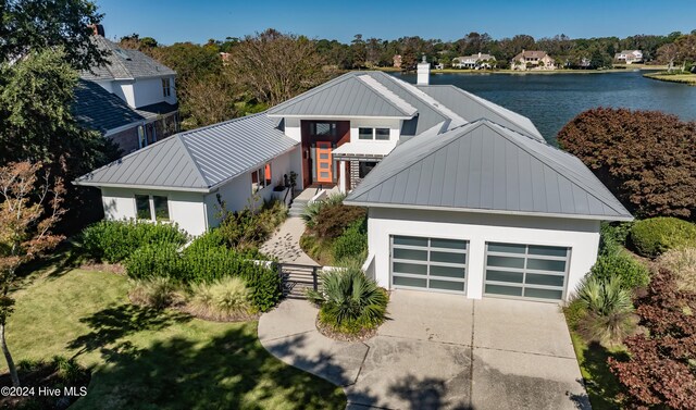 view of front of home with a water view and a garage