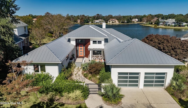 view of front of house with a water view and a garage