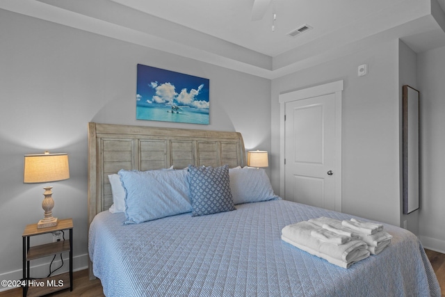 bedroom featuring dark hardwood / wood-style flooring and ceiling fan