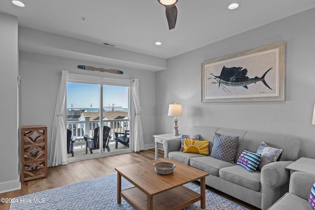 living room featuring ceiling fan and light wood-type flooring