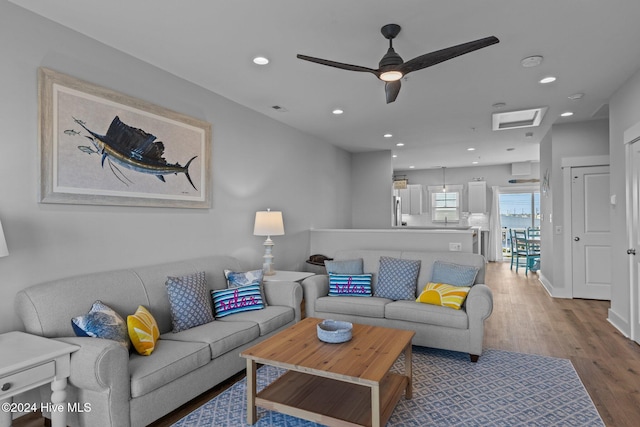 living room featuring hardwood / wood-style flooring and ceiling fan