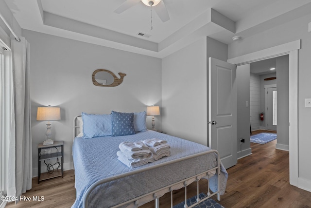 bedroom with hardwood / wood-style flooring and ceiling fan