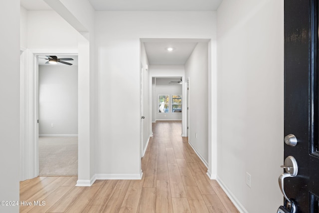 hallway with light hardwood / wood-style flooring