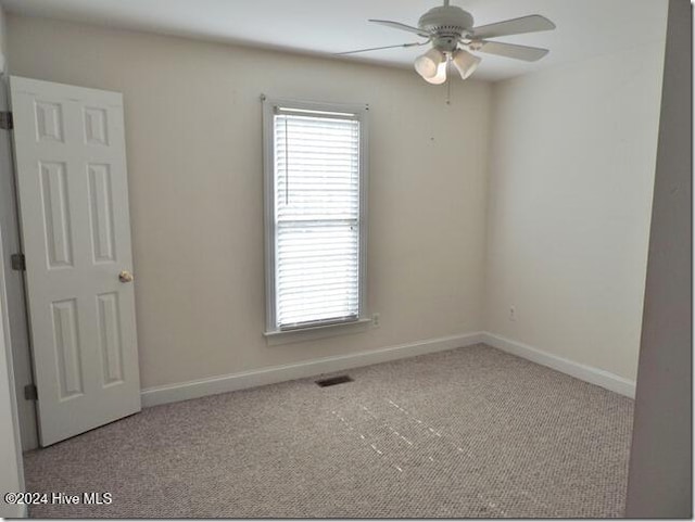 carpeted empty room with ceiling fan