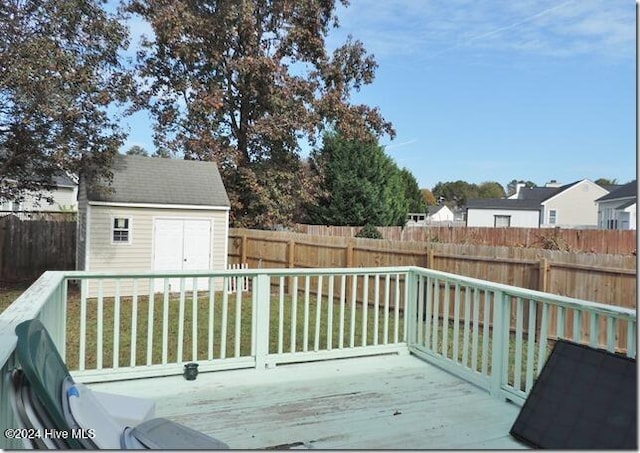 deck with a yard and a shed