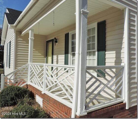 view of side of home with covered porch