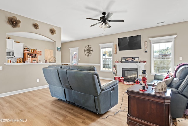 living room featuring ceiling fan and light hardwood / wood-style flooring