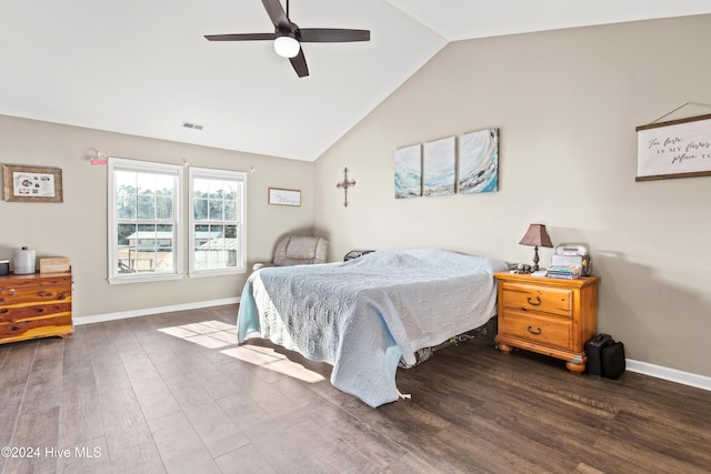 bedroom featuring ceiling fan, dark hardwood / wood-style flooring, and vaulted ceiling