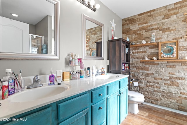 bathroom with hardwood / wood-style flooring, vanity, toilet, and an enclosed shower