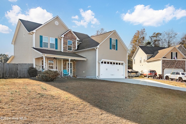 view of front of home featuring a porch, a garage, and a front lawn