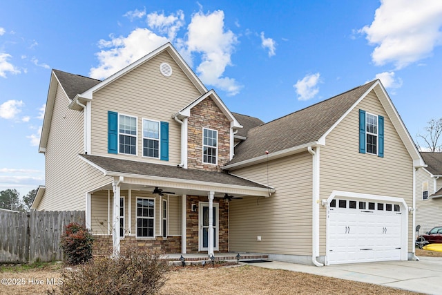 view of front property with ceiling fan, a garage, and covered porch