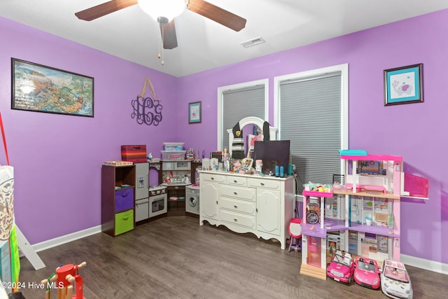 recreation room featuring dark hardwood / wood-style floors and ceiling fan